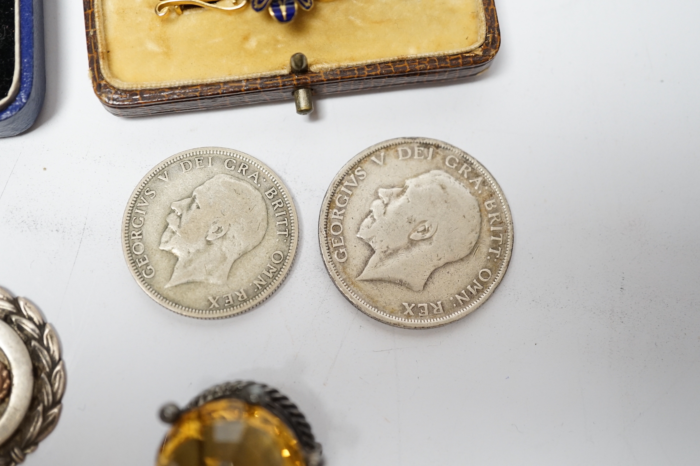 A pair of engine turned 9ct gold cufflinks, a yellow metal and enamel bar brooch, a white metal mounted citrine brooch, two silver medallions and two George V coins.